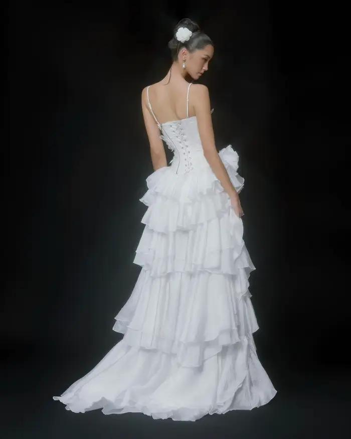 Robe de mariée blanche à ourlet asymétrique avec décolleté en V profond