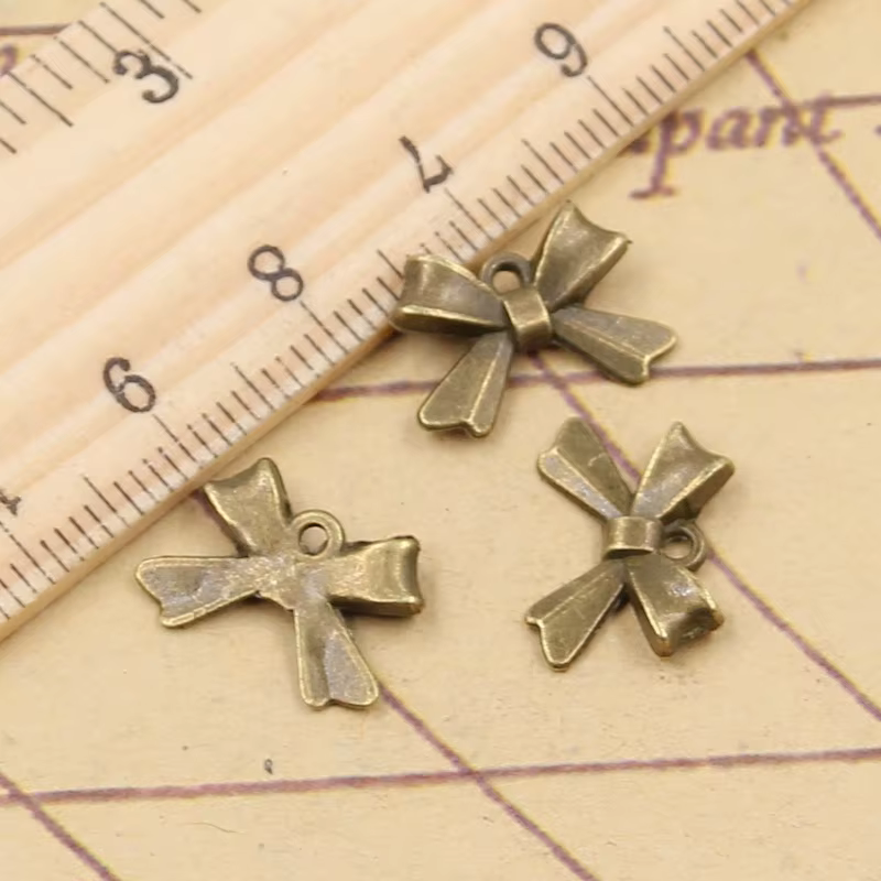 20 pièces nœud papillon 10x14mm tibétain Bronze argent couleur pendentifs Antique fabrication de bij