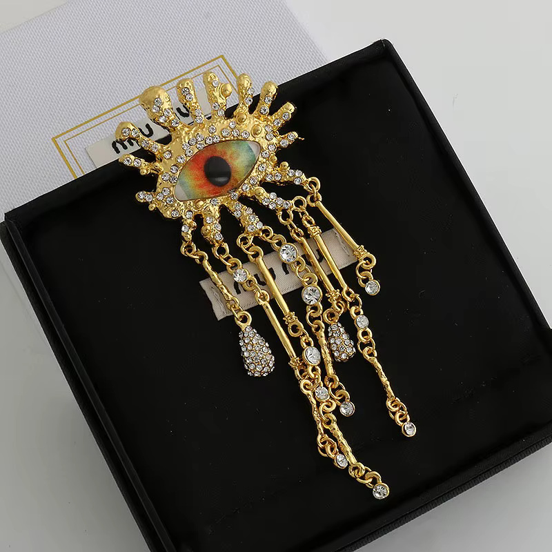 Broche rétro en strass en forme d'oeil pour femmes et hommes, chaîne à pampilles, épingles à revers,