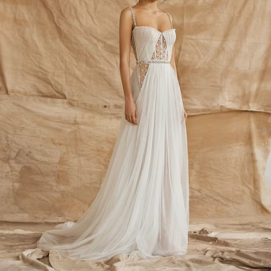 Robe de mariée à fines bretelles, dos nu, exquise, ornée de paillettes et de perles de cristal, long