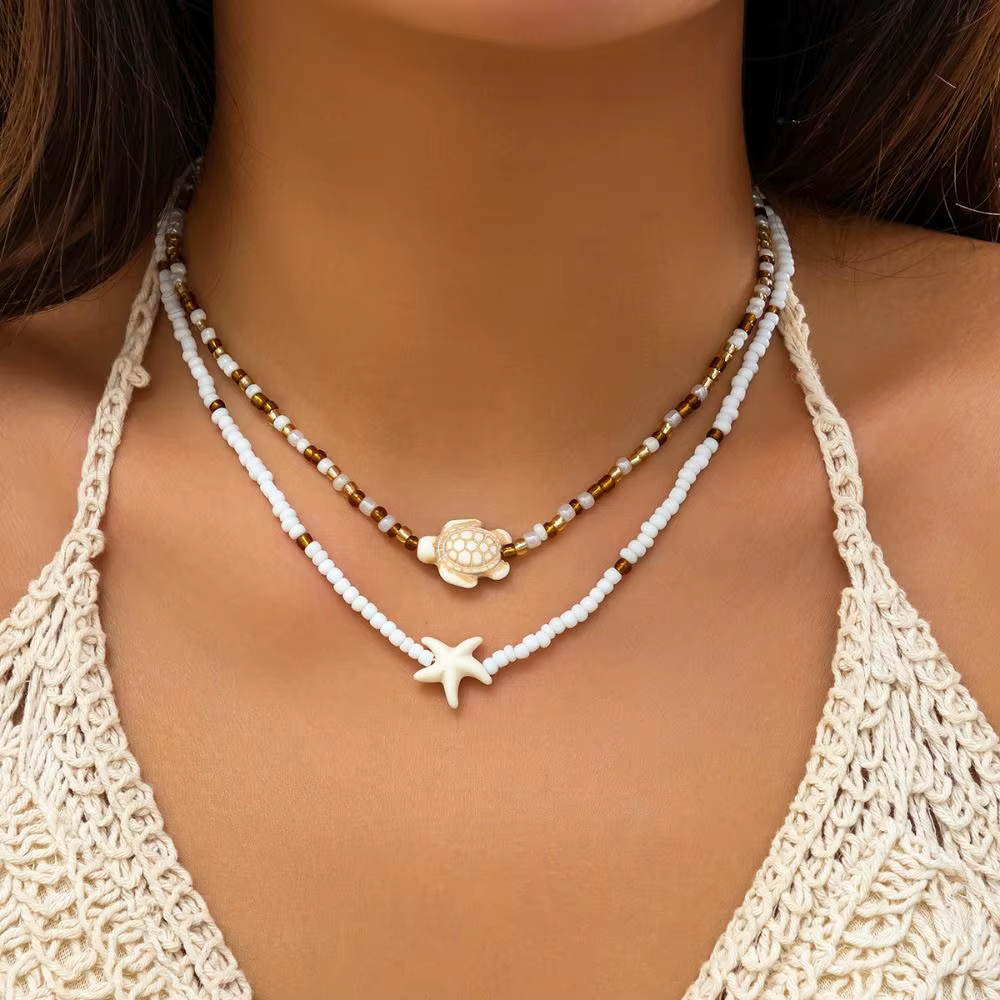 Collier avec pendentif coquillage et étoile de mer